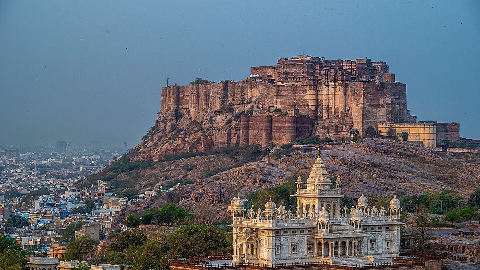 A fort rising above the old city at dusk